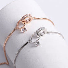 Load image into Gallery viewer, Image shows rose gold and silver Amadeus Charm Bracelets on a bracelet holder.