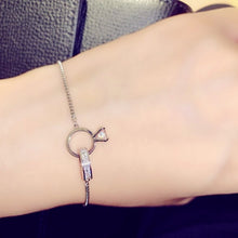 Load image into Gallery viewer, Image shows silver Amadeus Charm Bracelet on a model's wrist.