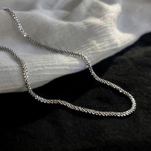 Load image into Gallery viewer, Image shows Arianwyn Chain lying on black and white fabrics.