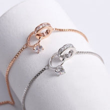 Load image into Gallery viewer, Image shows rose gold and silver Amadeus Charm Bracelets on a bracelet holder.
