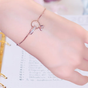 Image shows rose gold Amadeus Charm Bracelet on model's wrist.