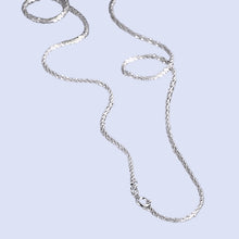 Load image into Gallery viewer, Image shows Arianwyn Chain laid on a pale blue background.
