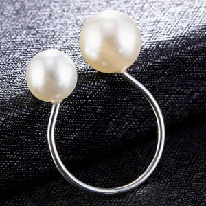 Image shows a silver-tone Bexley Pearl Ring on a black surface.