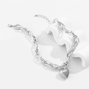 Image shows silver-finish Cathy Heart Necklace on a grey background.