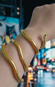 Image shows gold-tone Esme Serpent Necklace on model's wrist.