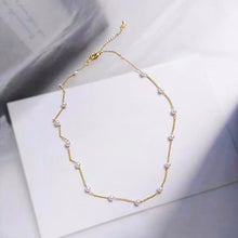Load image into Gallery viewer, Image shows Gretel Pearl Choker laid on a flat white surface.
