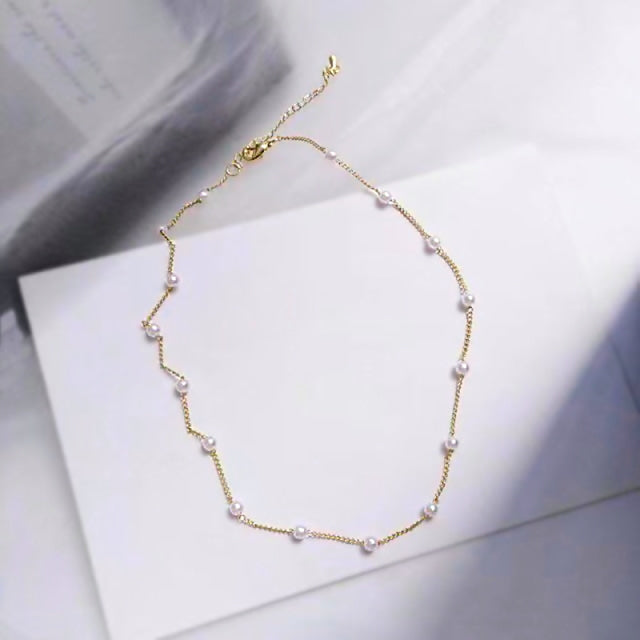 Image shows Gretel Pearl Choker laid on a flat white surface.