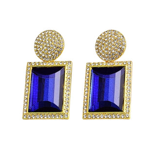 Image shows blue and gold Margot Statement Earrings on a white background.