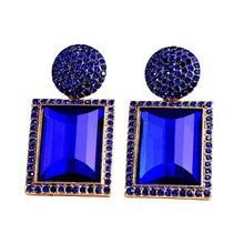 Load image into Gallery viewer, Image shows blue Margot Statement Earrings on a white background.
