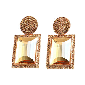 Image shows champagne and gold Margot Statement Earrings on a white background.